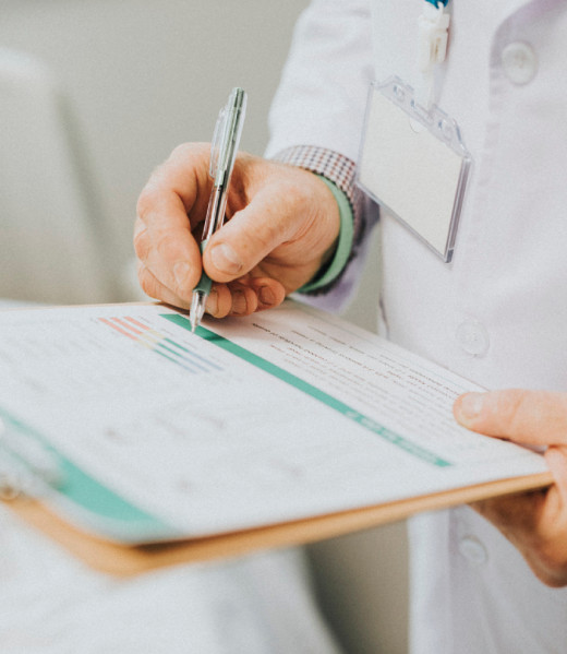 Physician noting down symptoms of a patient Physician noting down symptoms of a patient