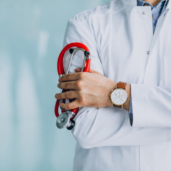 Young handsome physician in a medical robe with stethoscope Young handsome physician in a medical robe with stethoscope