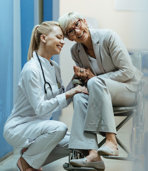 happy-mature-woman-wheelchair-holding-hands-with-her-female-doctor-hospital-hallway-looking-camera happy-mature-woman-wheelchair-holding-hands-with-her-female-doctor-hospital-hallway-looking-camera